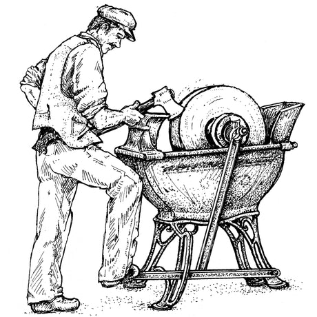 Sharpening an axe on foot pedal grinding stone.